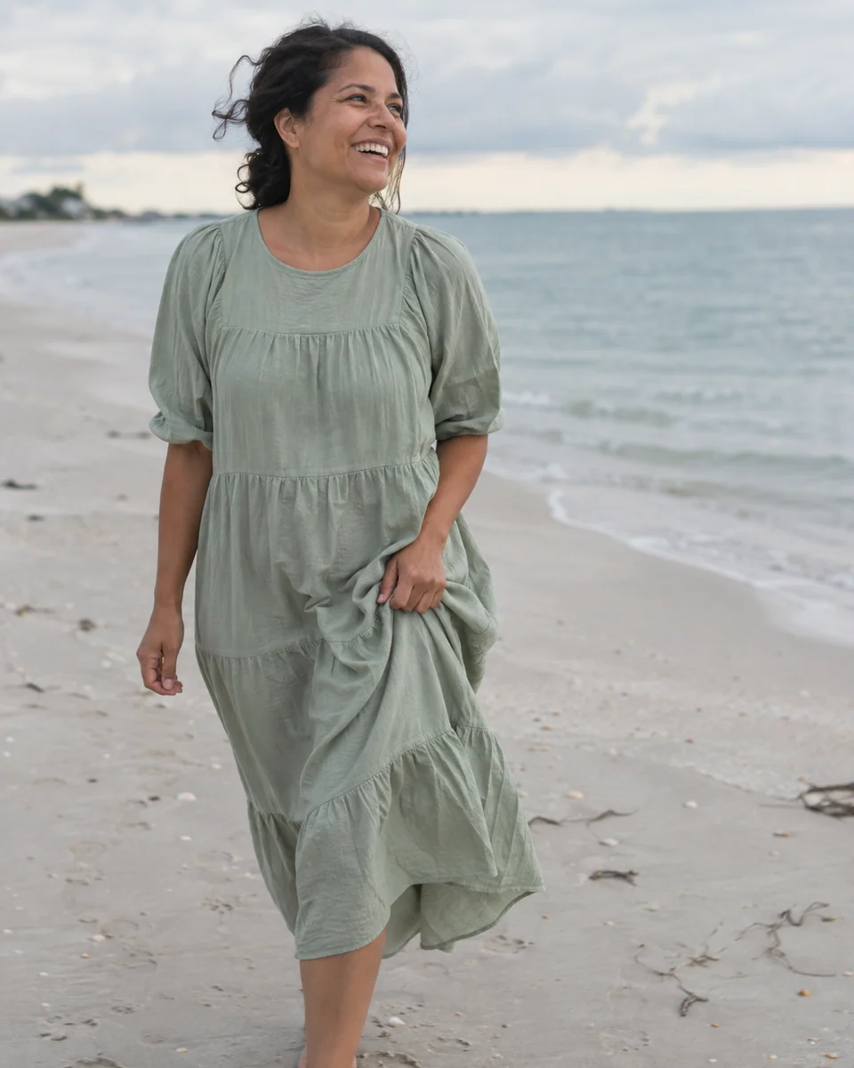 Illustrative photograph of a woman enjoying a walk on the beach